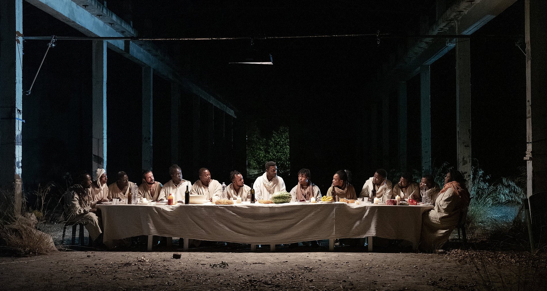 Schauspieler des Films sitzen nachts um den Tisch des Letzten Abendmahls.